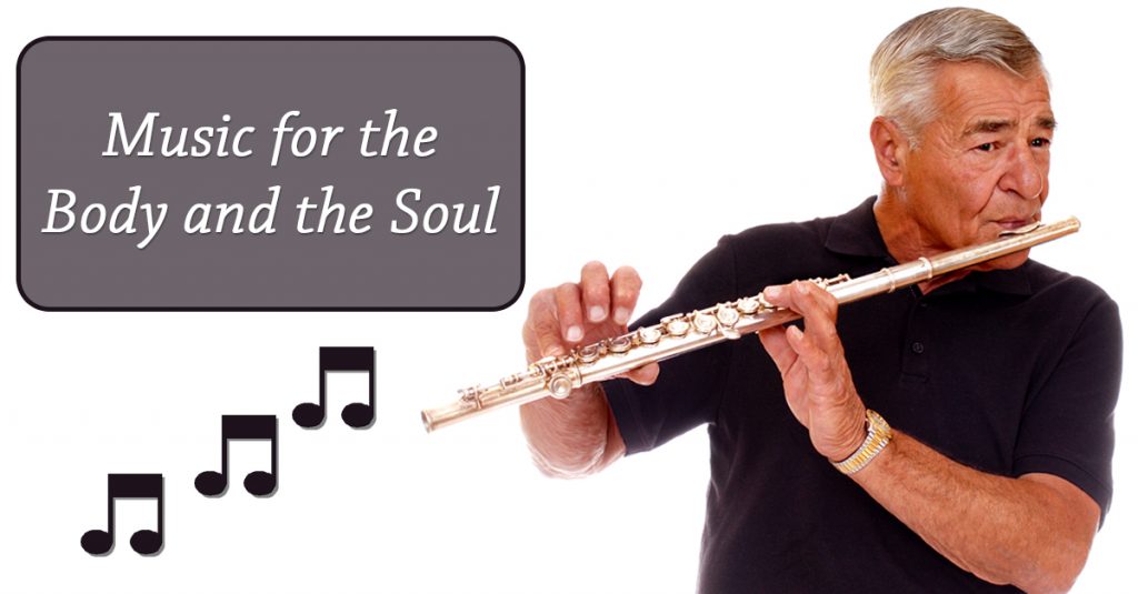 A Caucasian man playing a flute with text "Music for the Body and the Soul"
