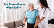 Fall Prevention in Older Adults. Picture of an elderly caucasian female being assisted with her walker by a young caucasian female physical therapist.