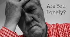 Social Isolation Causes Health Effects for Seniors. Picture of an older caucasian male holding onto his head as if in frustration or sadness.